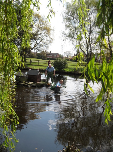 The new duck house being installed, the flotation collar is retrieved.