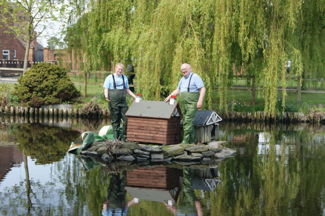 Joe Young and Ian Jones installing the new duck house on Hankelow pond